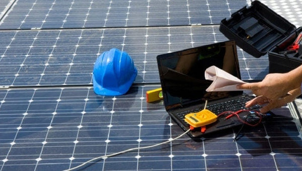 healthy and safety inspectors looking at solar panels 