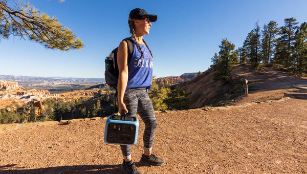 woman carrying a portable solar generator